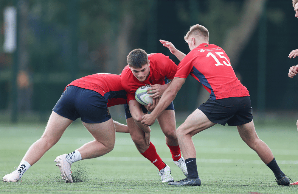 Three men in an action shot playing rugby