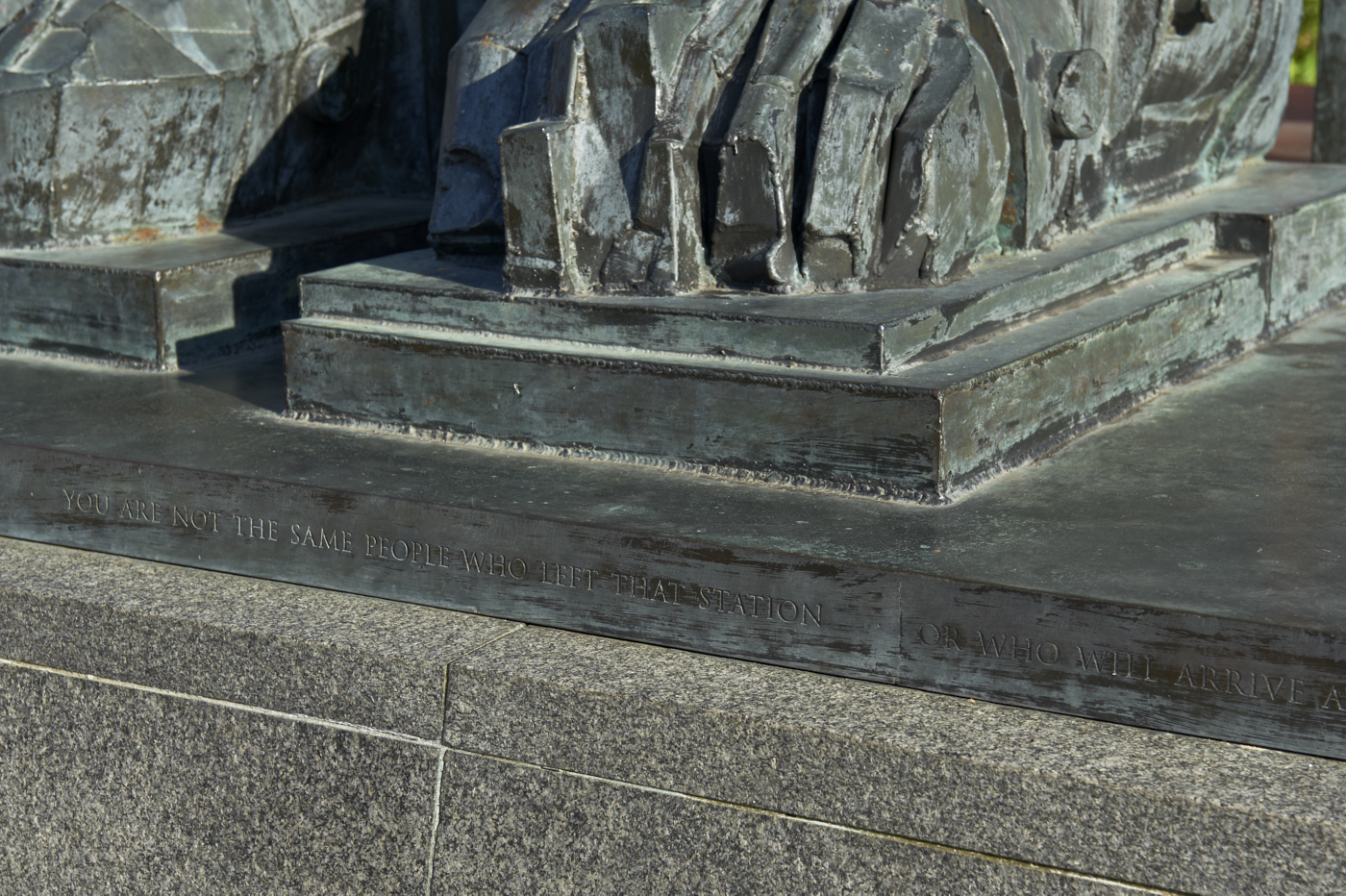 Feet and poetry inscription at the base of bronze sculpture Faraday by Eduardo Paolozzi