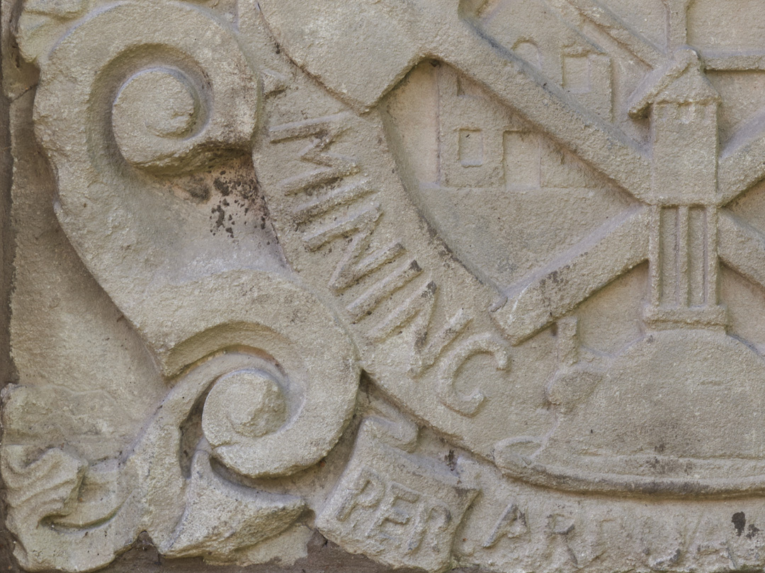 Close up detail of carved stone heraldic shield from the Mining Department