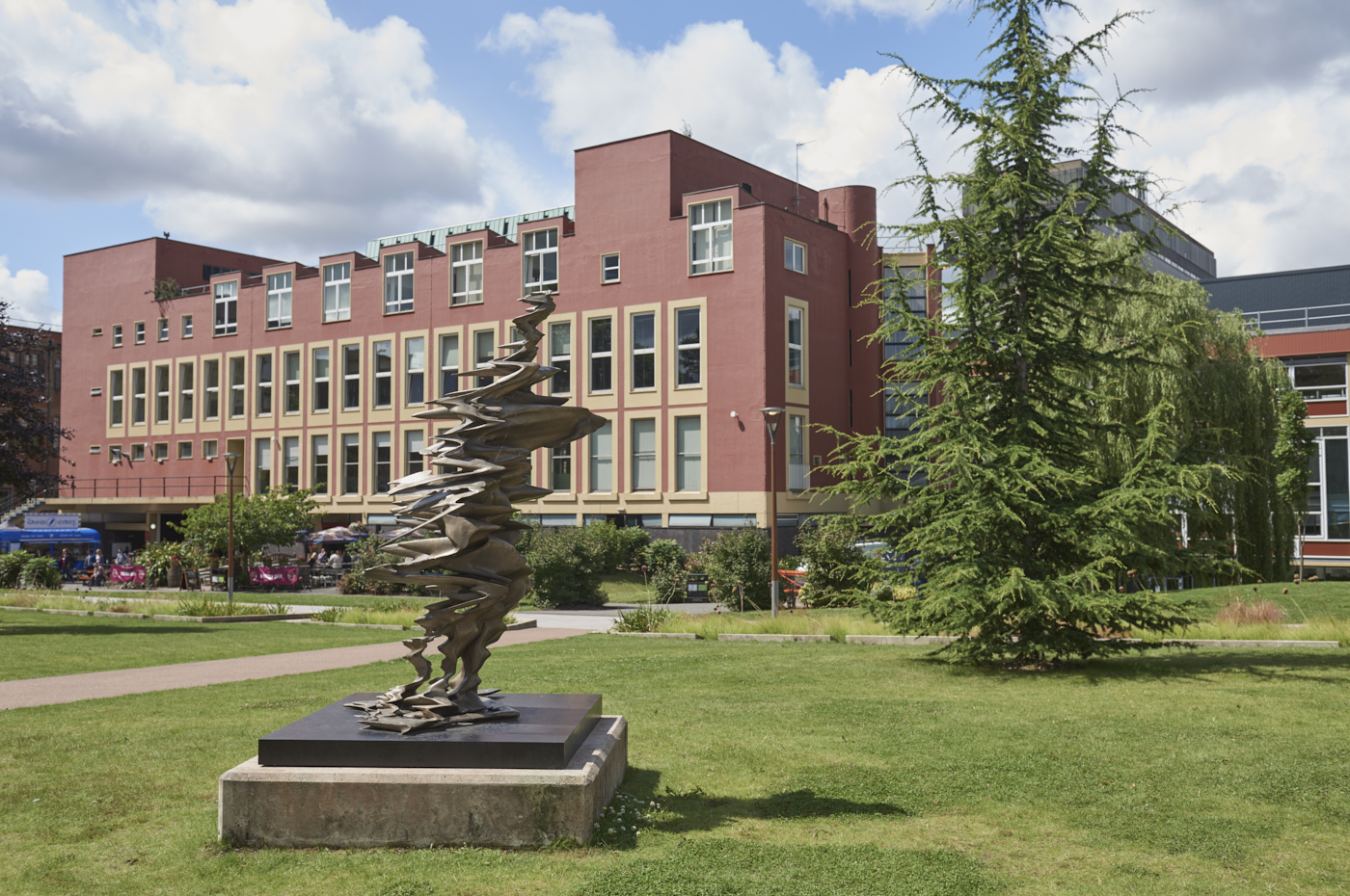 Bronze sculpture Father Sky/Uranus by Zachary Eastwood-Bloom in context with Staff House behind