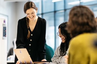 student and staff at laptop