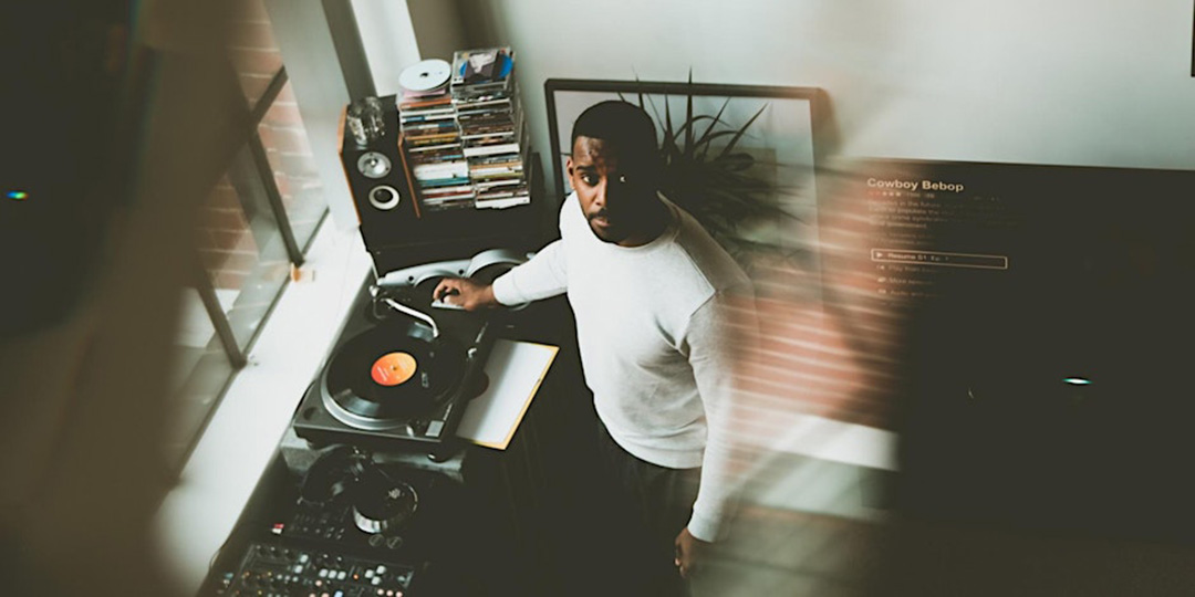 Jayson Winters standing in front of his record player