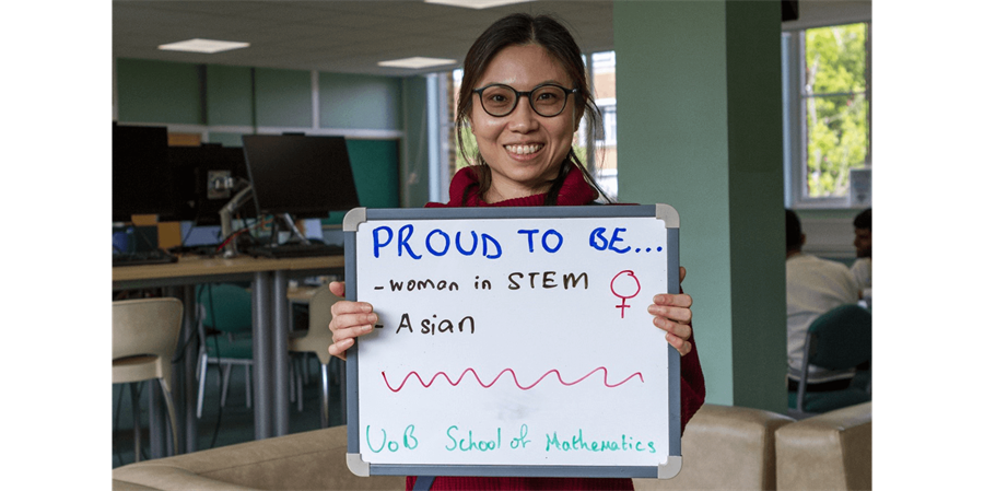 Yin Hoon Chew holding a sign saying Proud to be woman in STEM, Asian, UoB School of Mathematics