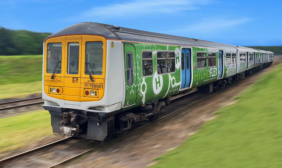 Green Hydroflex hydrogen powered train running along a railway track