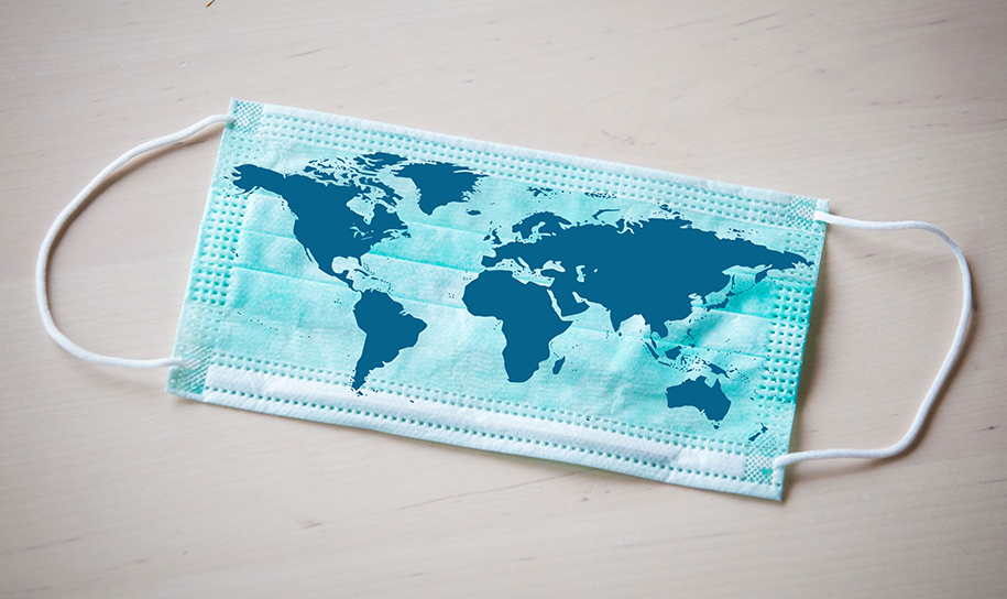 A face mask with a map of the world placed on top.