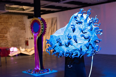 Large blue 3D sculpture of bacteria