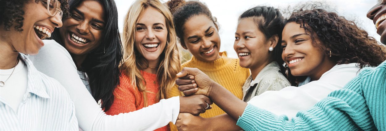 Group of women with there hands in the middle