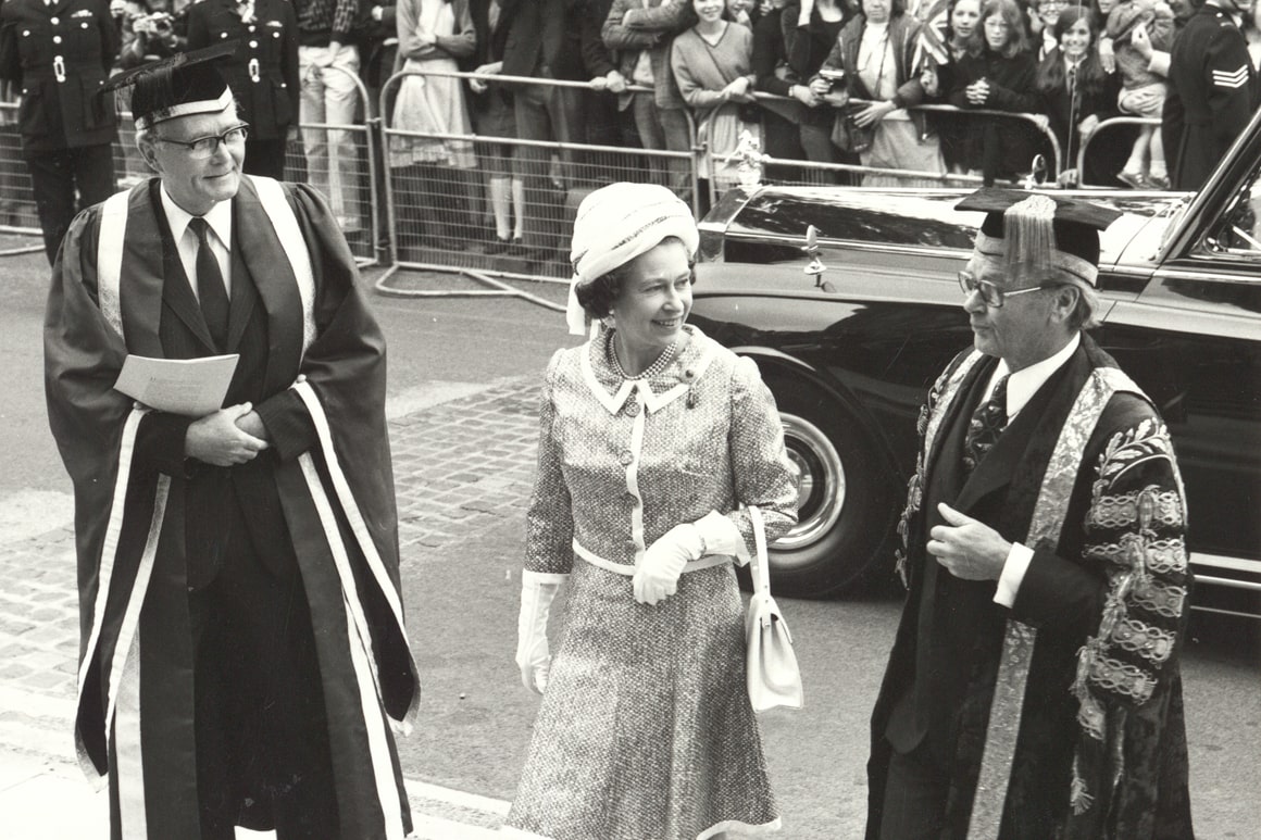 A black and white image of Queen Elizabeth II during a visit to campus in 1975