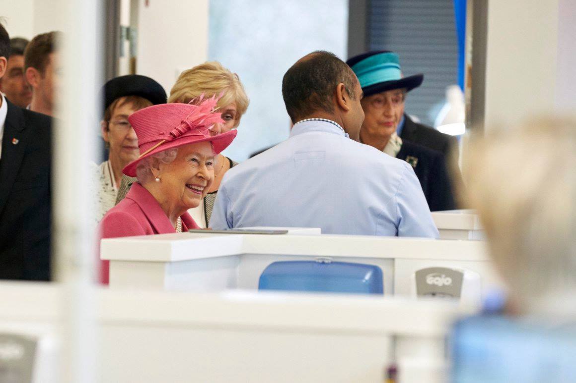 Queen Elizabeth II smiling and talking with staff at the opening of the University of Birmingham's Dental School in 2015