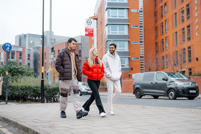 Three students walking through Selly Oak.