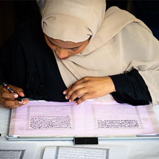 Person transcribing the Qur'an