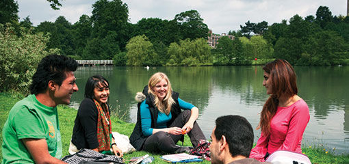 Students socialising by the lake at Birmingham&#39;s student accomodation