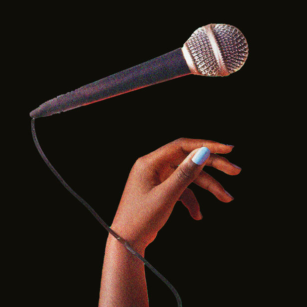 A hand and a microphone sit against a black background.