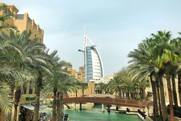 Burj al Arab hotel with canel and palm trees in foreground