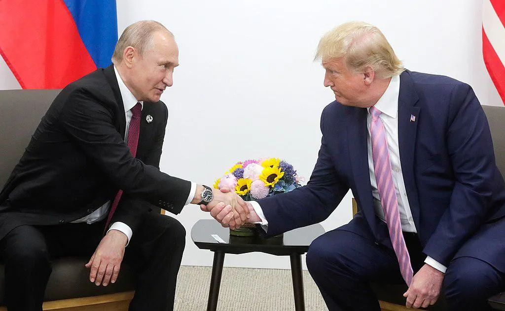 Vladimir Putin and Donald Trump meeting and shaking hands in 2019. 