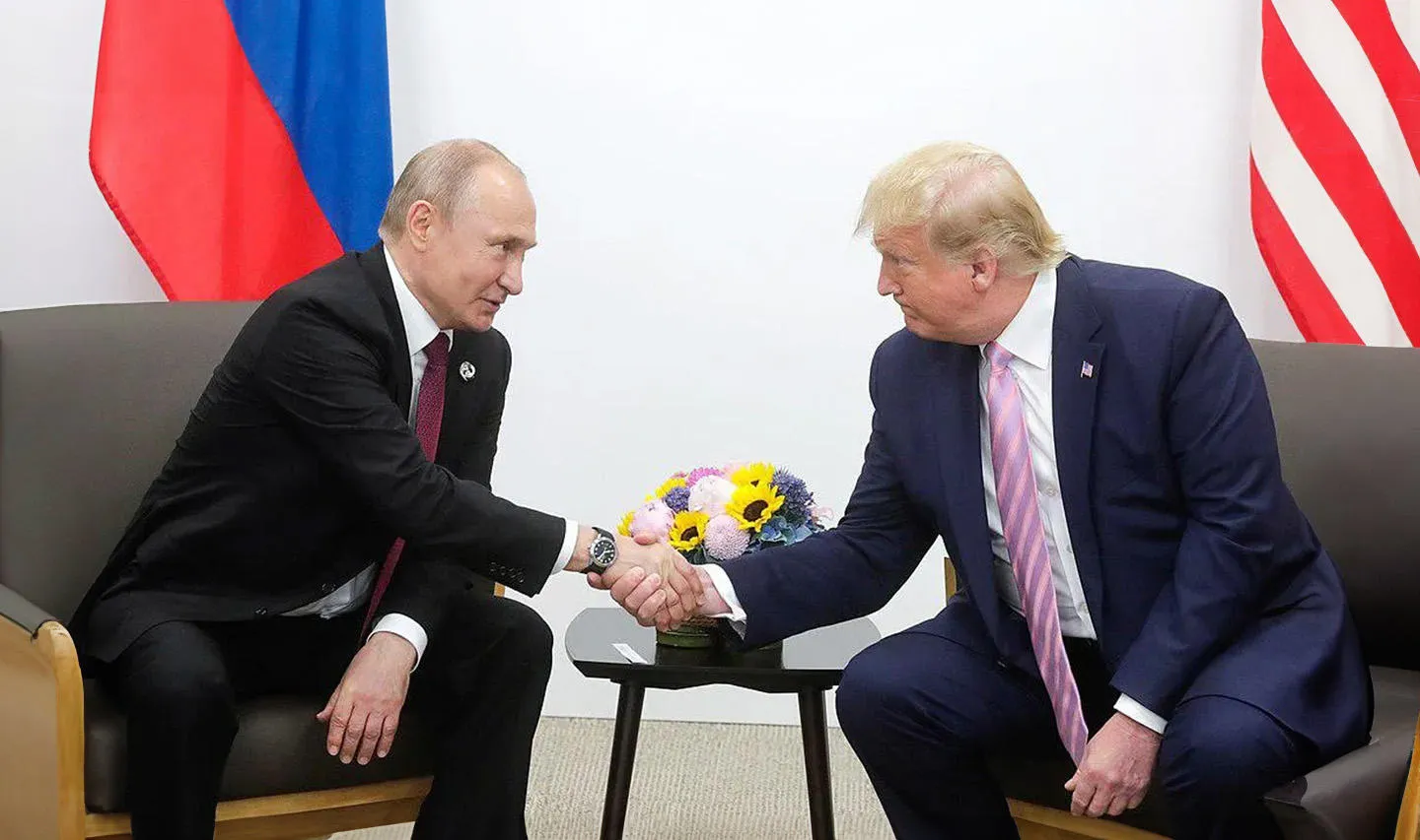 Vladimir Putin and Donald Trump meeting and shaking hands in 2019. 