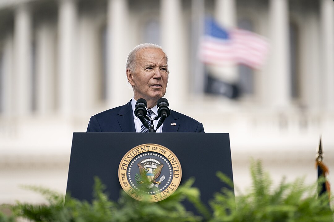Joe Biden speaking at a podium in front of the Capital building in Washington