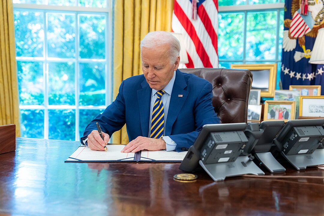 President Joe Biden at the desk in the Oval Office.