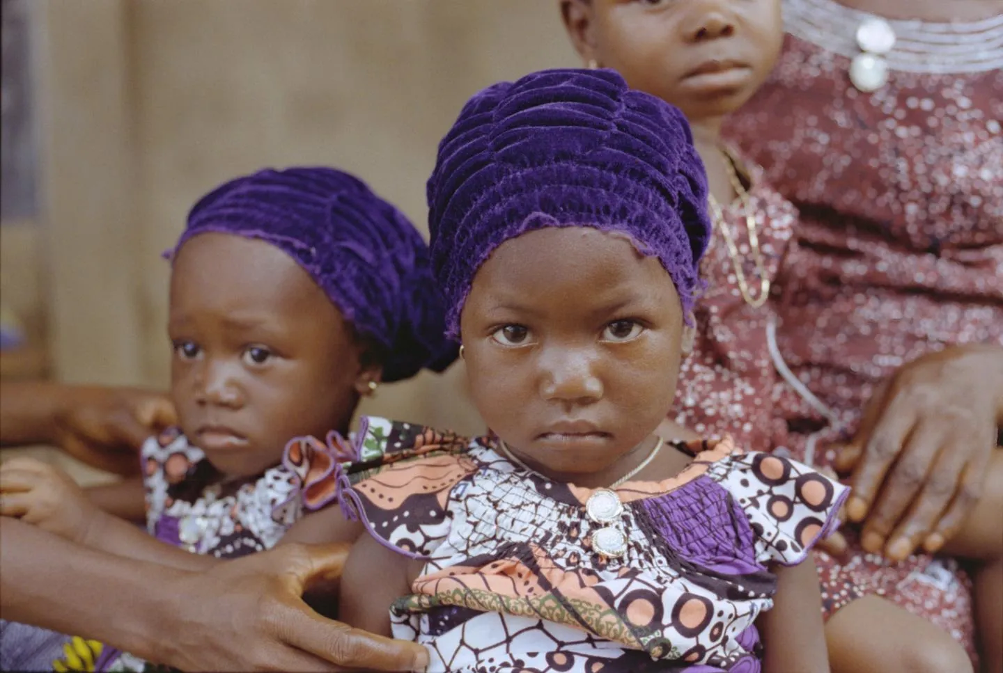 Two young girls stare at the camera