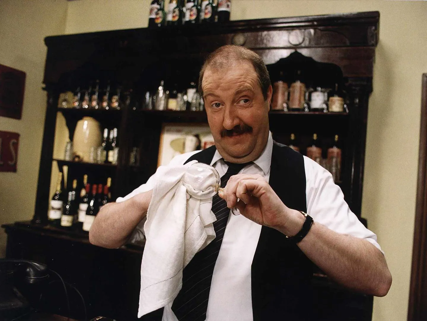 Actor Gorden Kaye looks at the camera dressed as Rene Artois, the bar owner in BBC TV comedy series 'Allo 'Allo