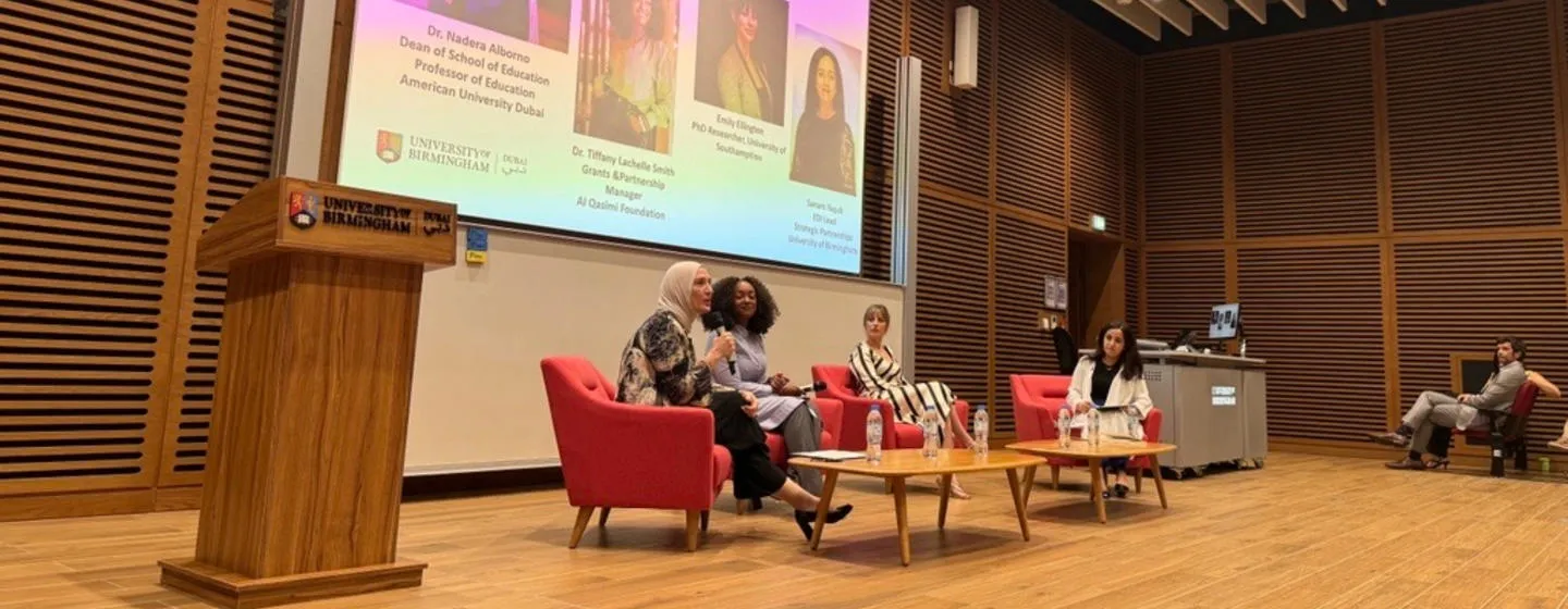 Panelists sat around a table in discussion 