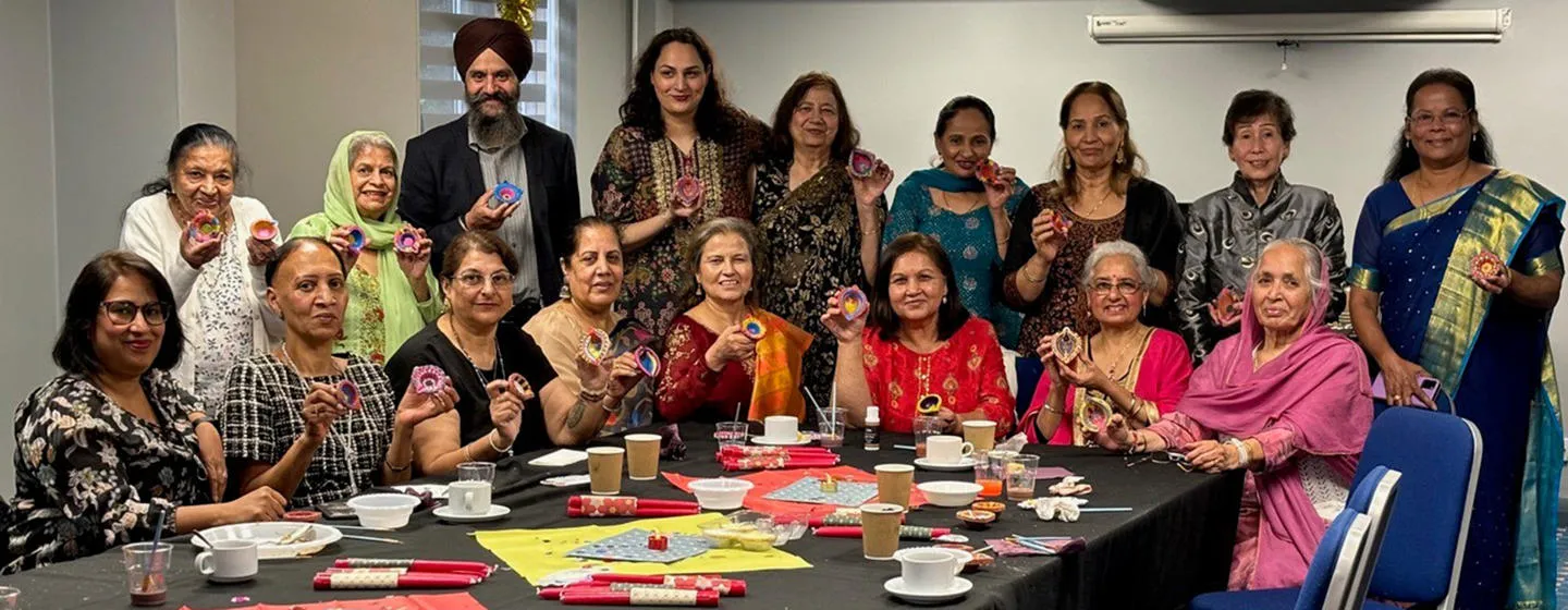 Group of South Asian older people showcasing their crafts.