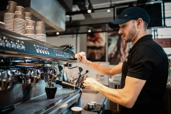 Food Fellows barista makes coffee