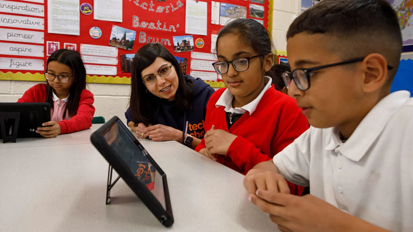 Children working with a tablet in a classroom