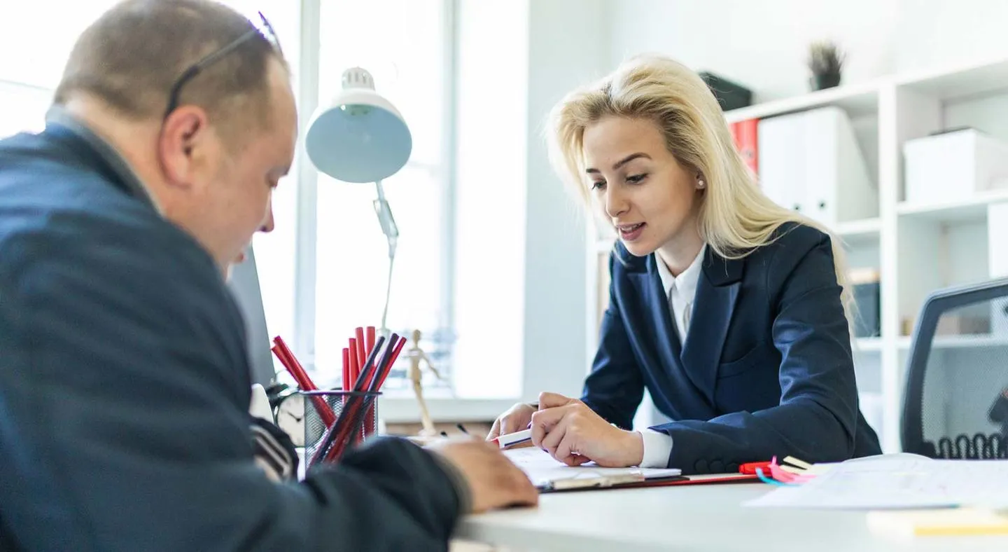 Man and woman in office looking at documents 