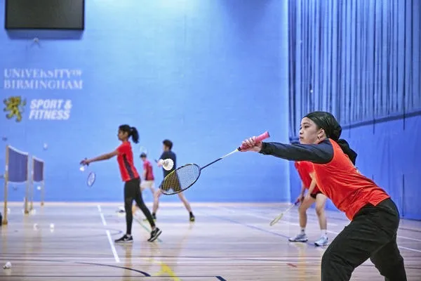 Women playing indoor badminton