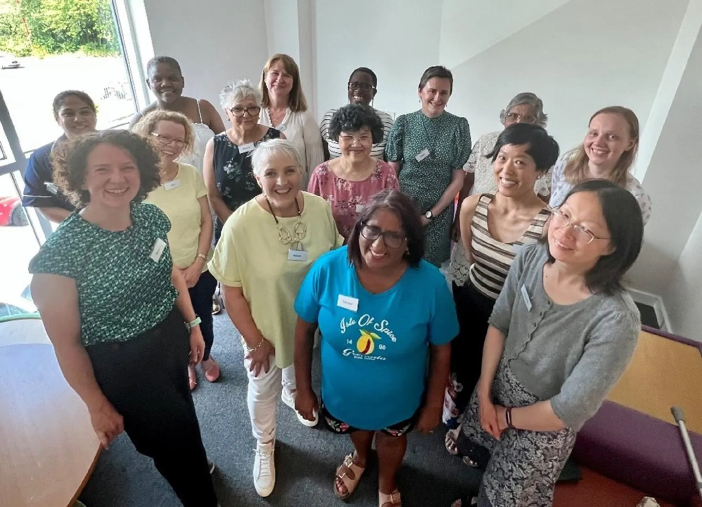 Members of the DEMO team stand in a group and smile at the camera.