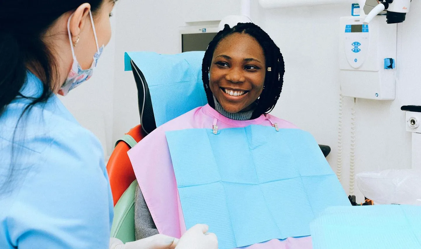 Woman sitting in a dental clinic smiling