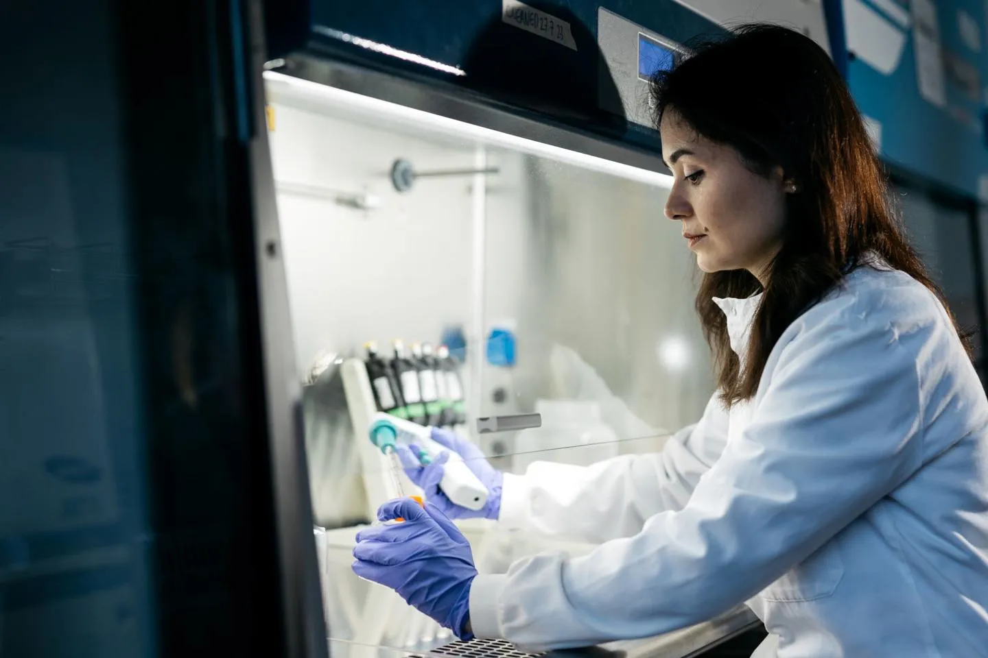 Female researcher pipetting in a laboratory