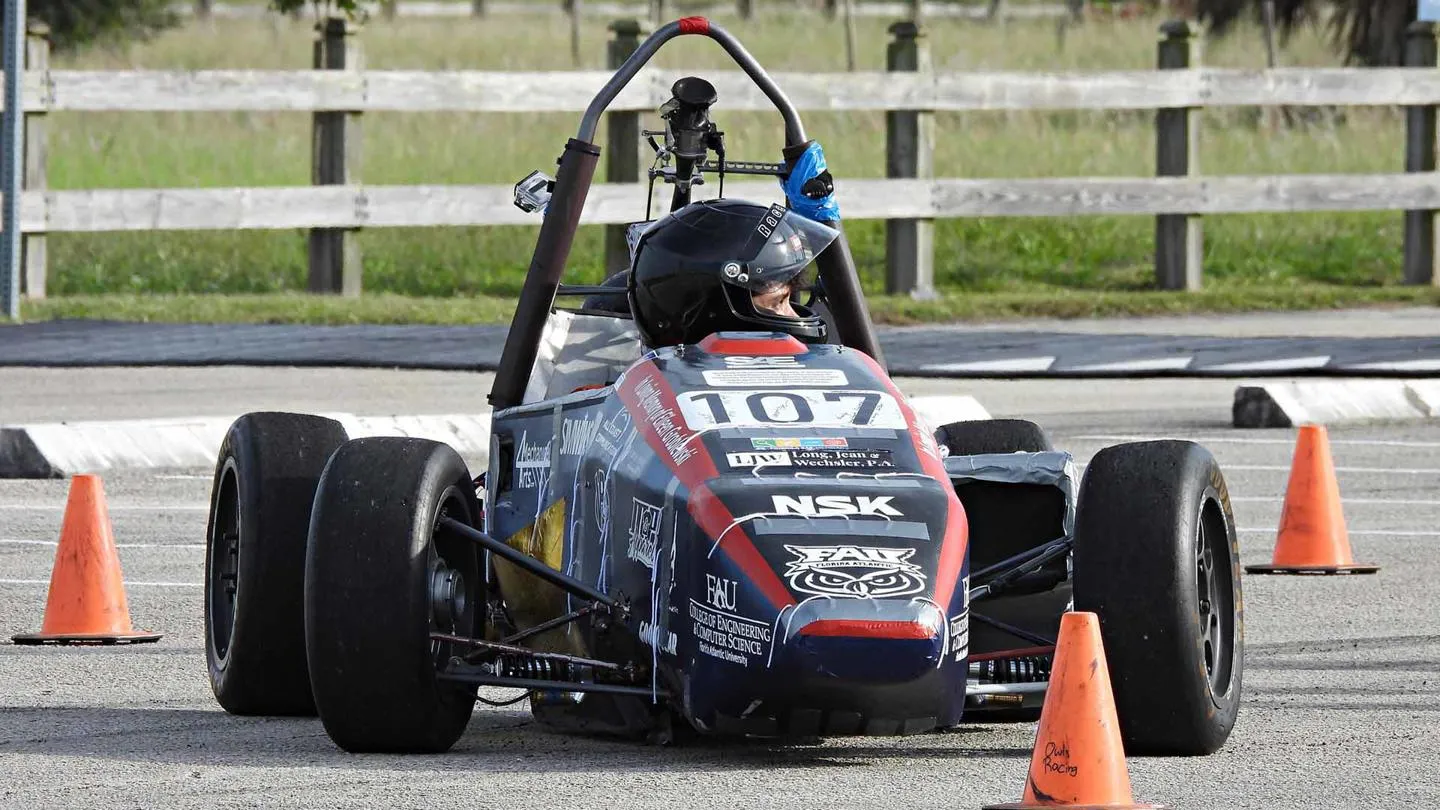 A young person in a formula racing vehicle