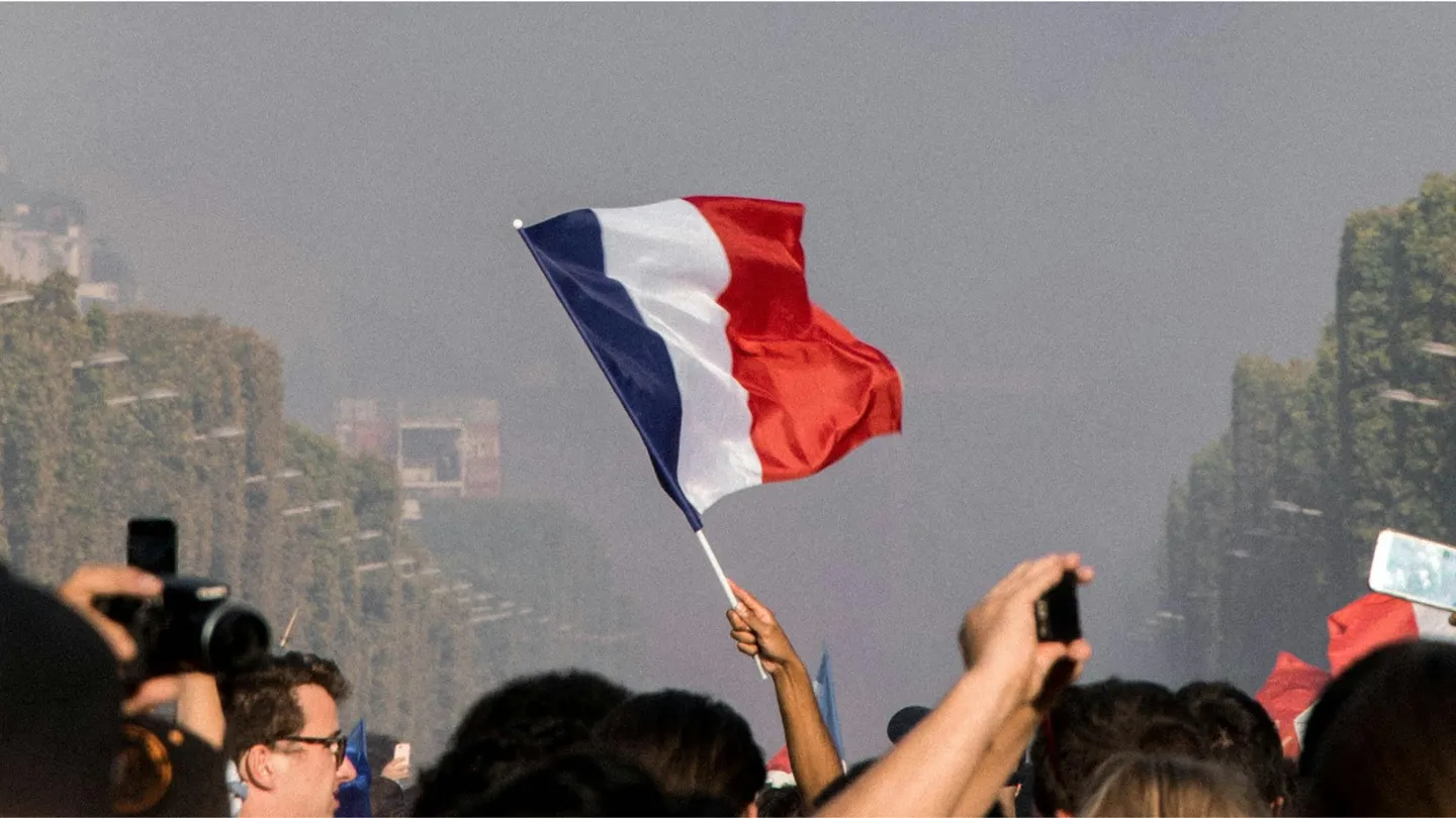 French flag being held up at a protest/gathering