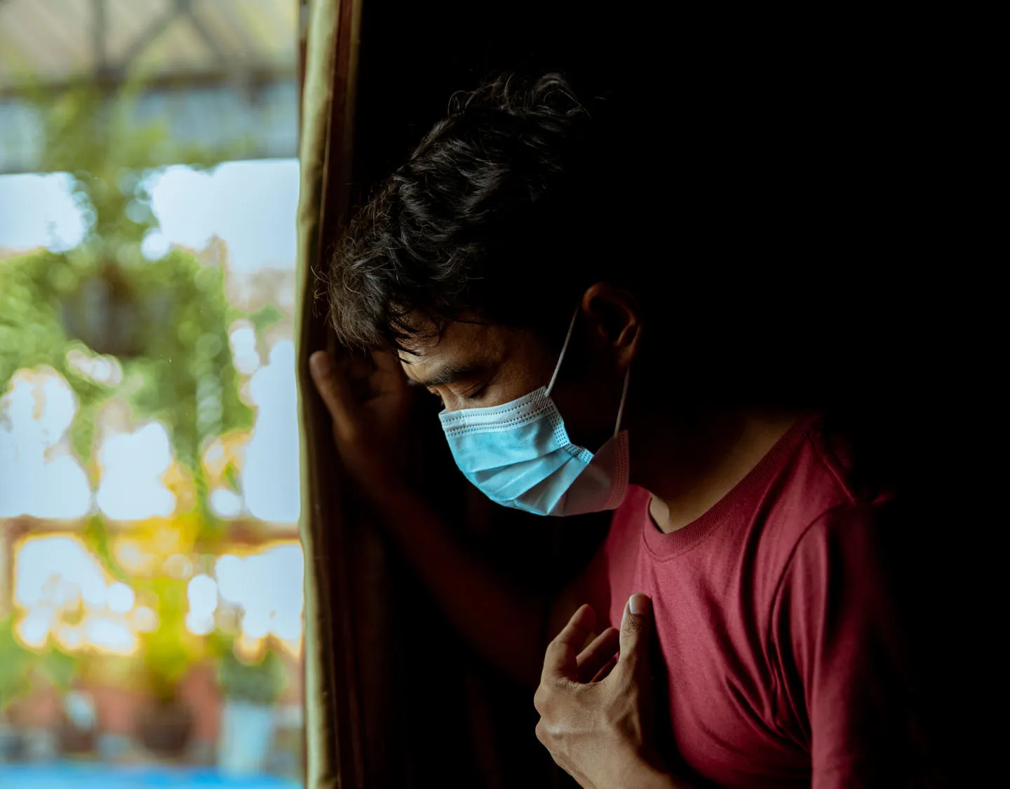 Man wearing mask, looking ill 