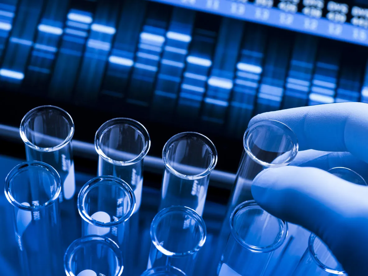 Researcher hand moving test tube in lab