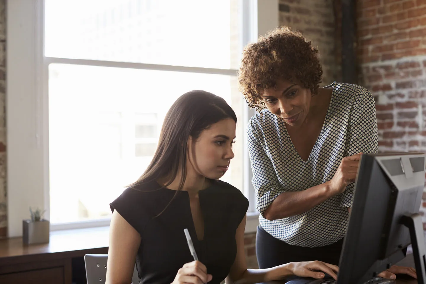 Tutor and apprentice work together on a computer