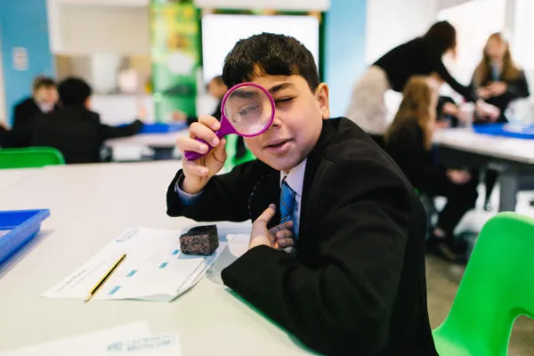 A student with a magnifying glass.