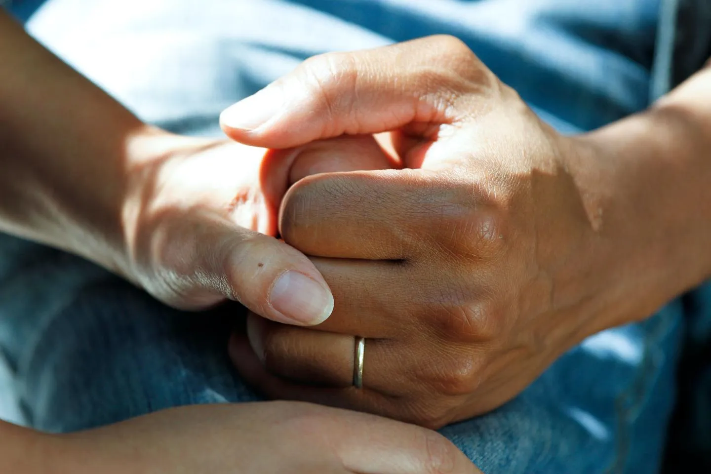 Two female hands clasped together