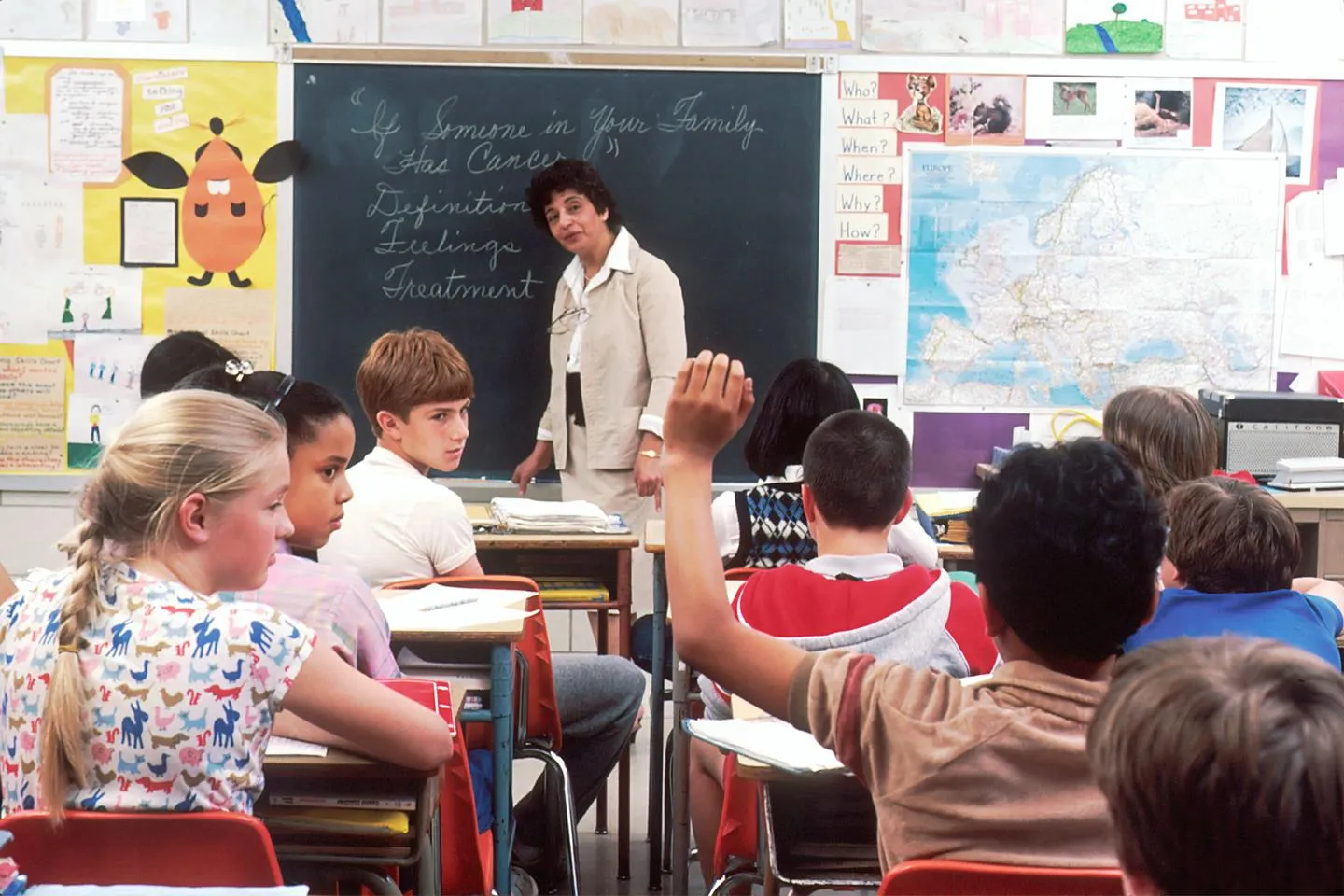 Teacher speaks to children in classroom