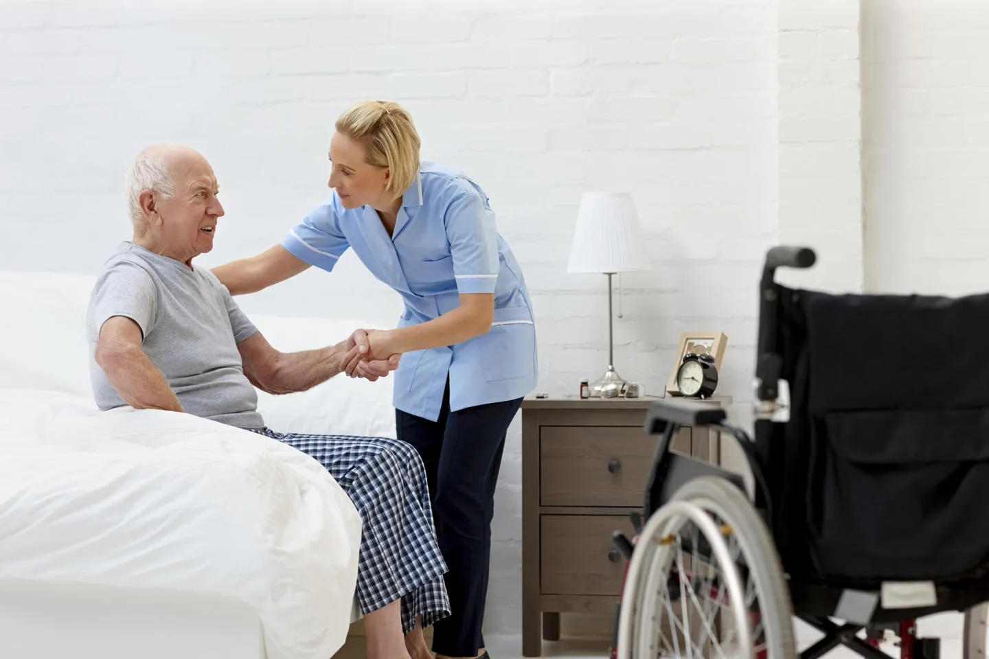 A nurse helping an elderly patient