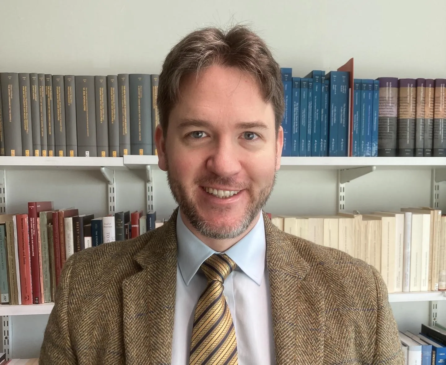 A person standing in front of books