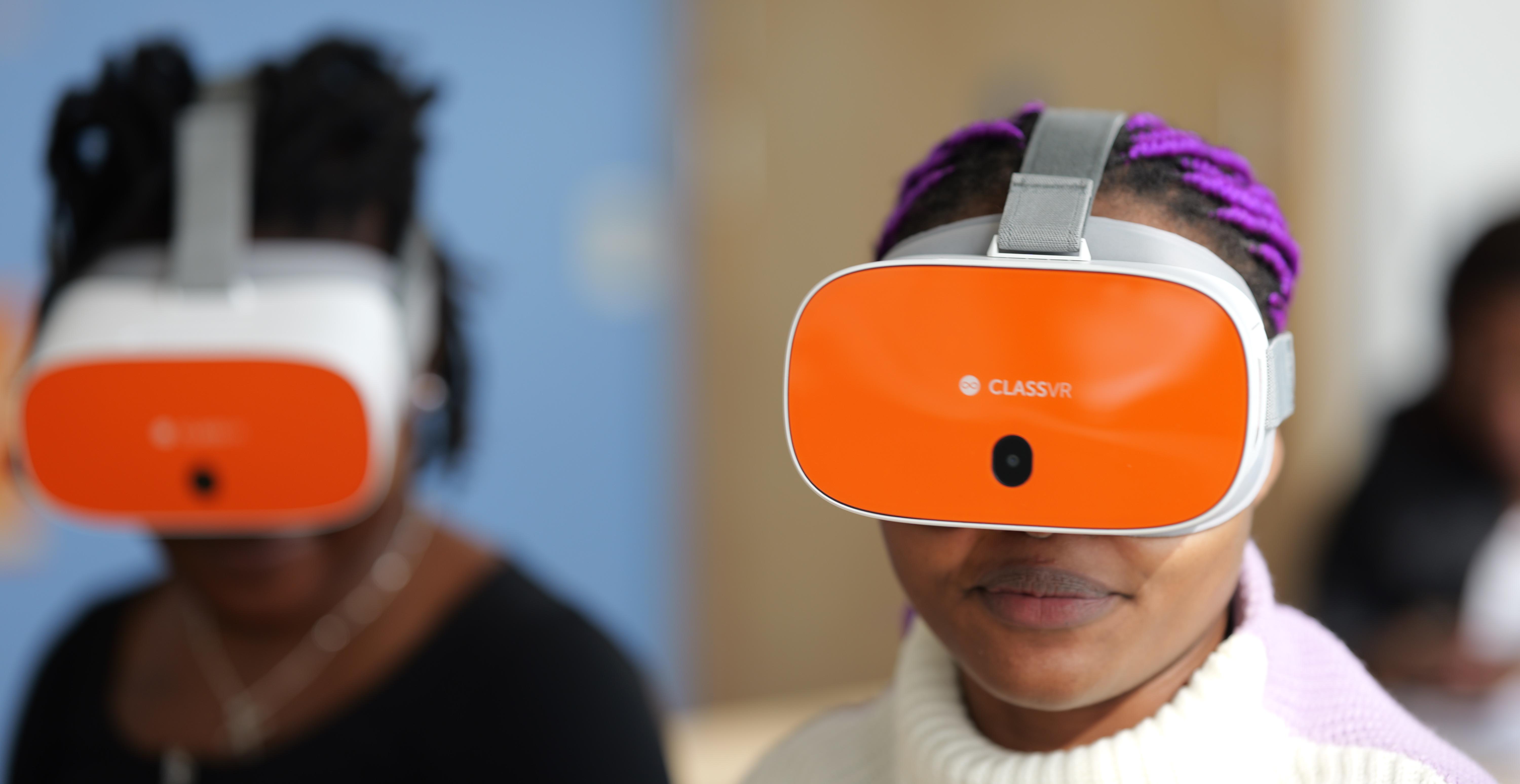 Two women using VR headsets to experience the new 360-degree video training package