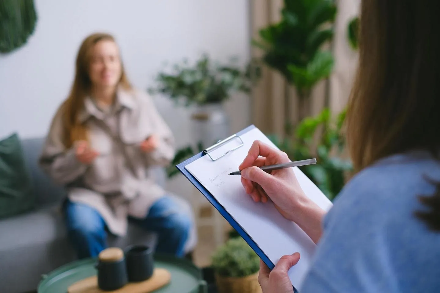 Doctor taking notes with a patient