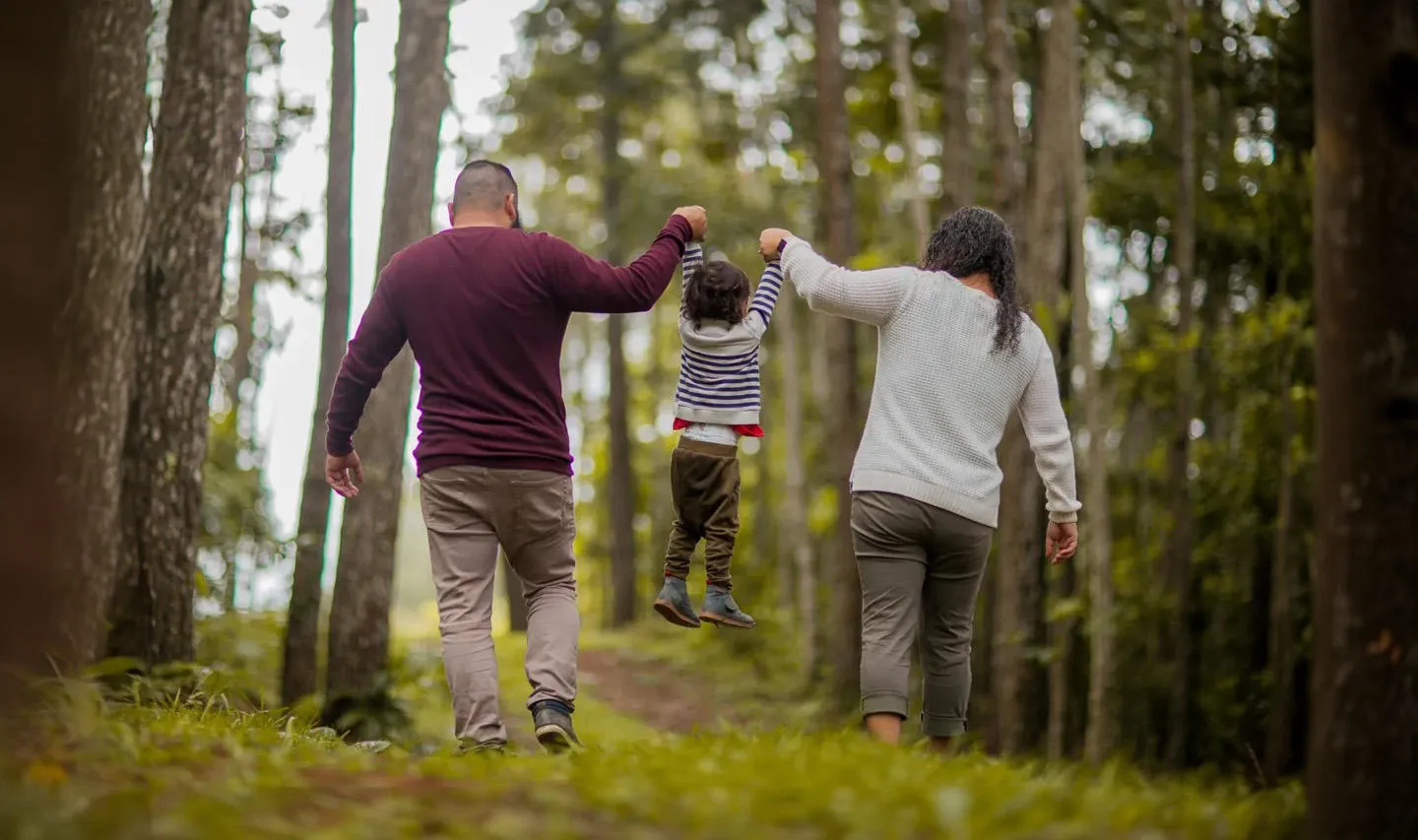 Parents holding hand with their small child