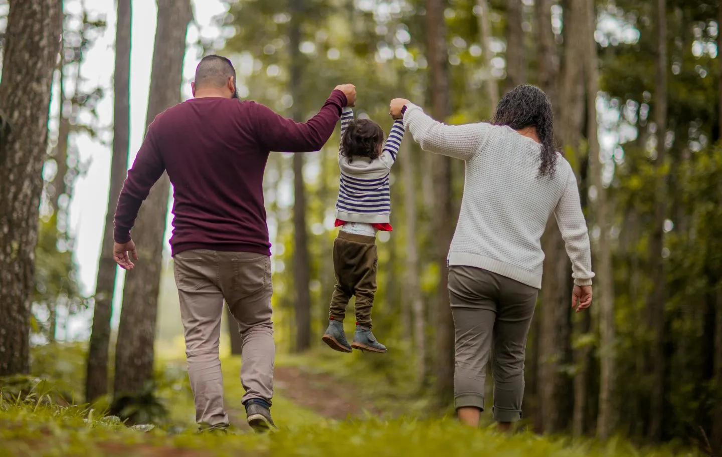 Parents holding hand with their small child