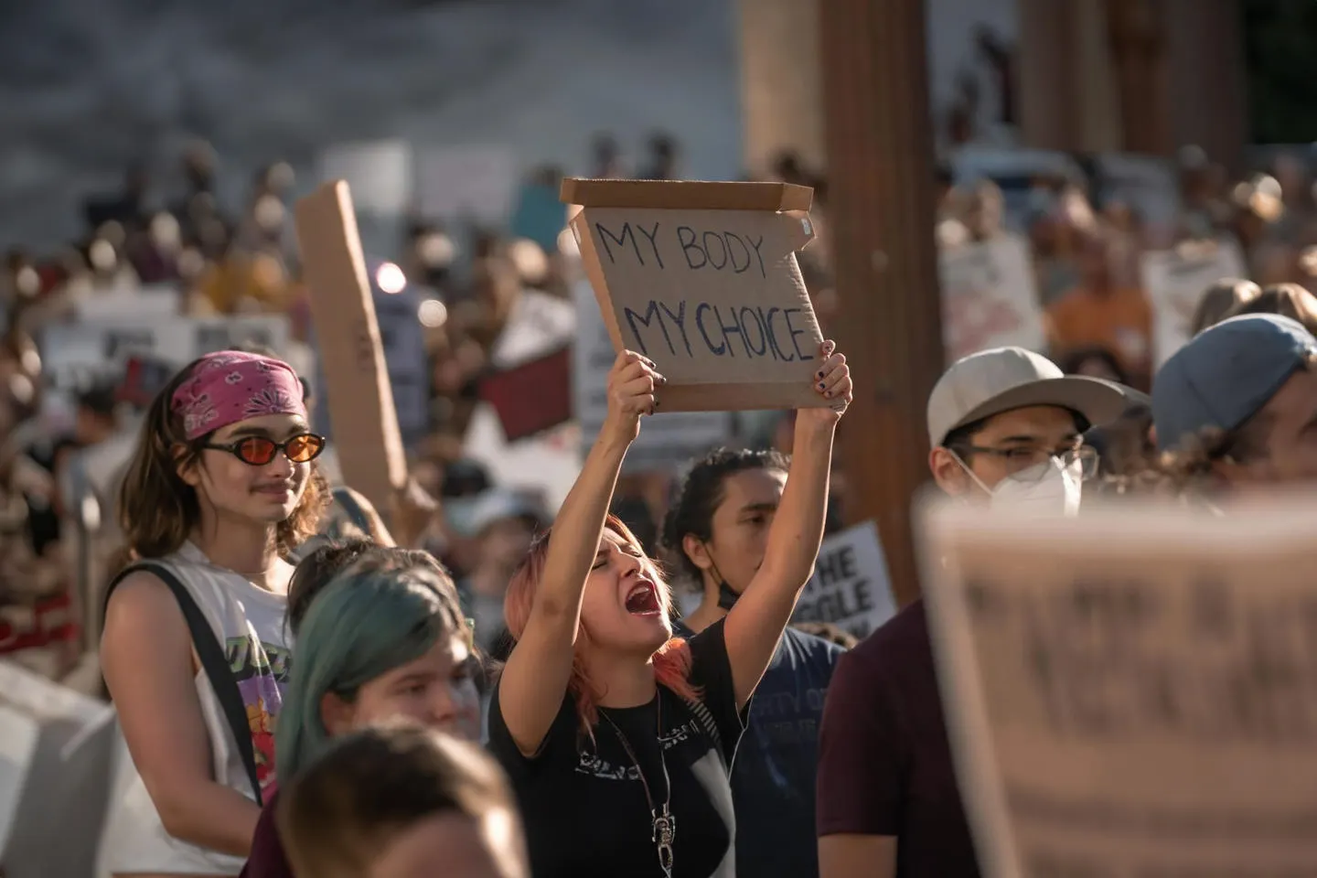 A woman holds up a my body, my choice sign at a protest in the USA. 