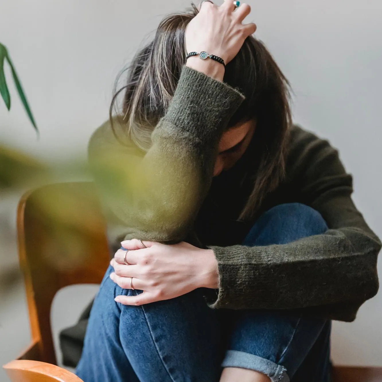 Woman holding her head in her right arm