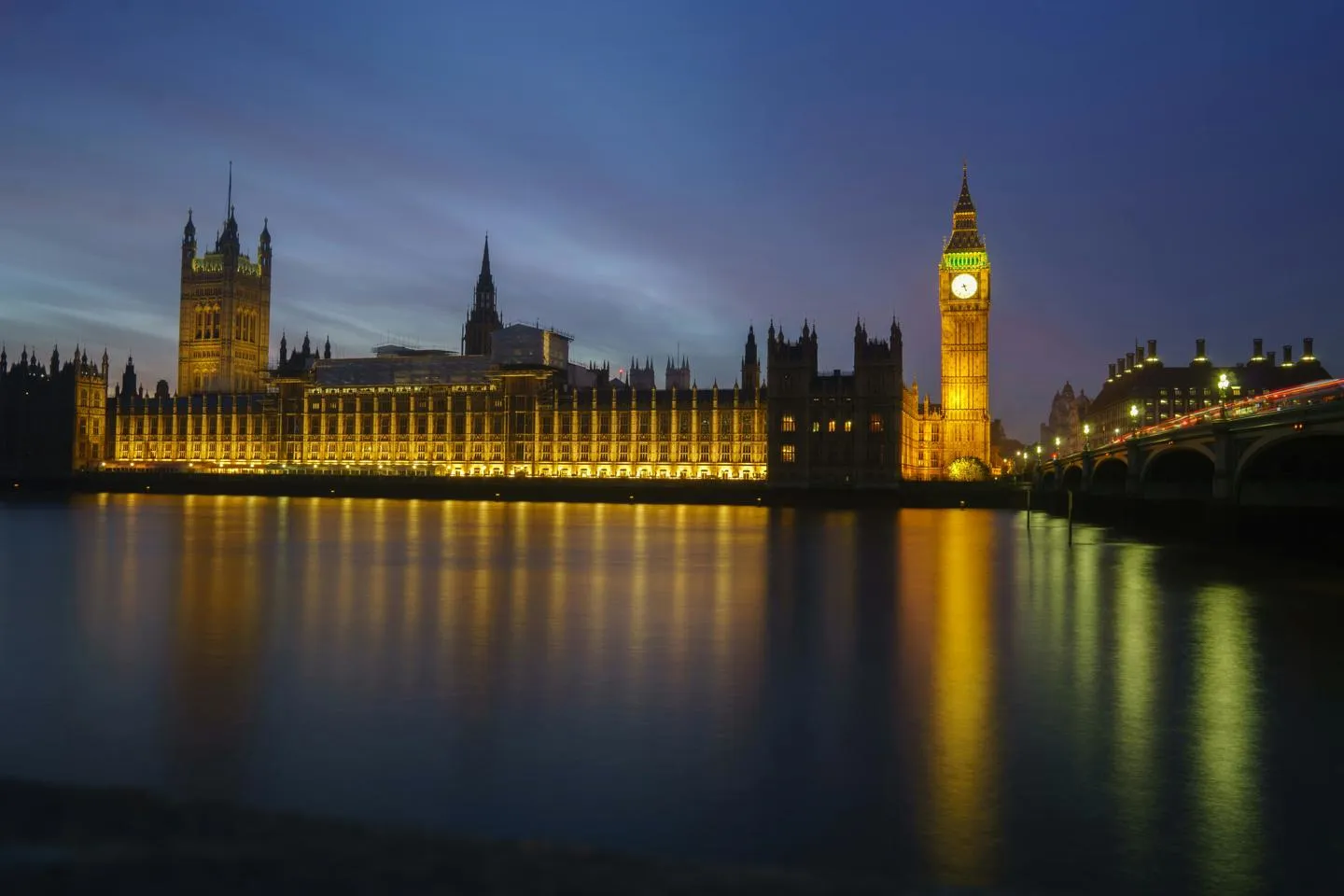 Parliament and Big Ben from the River Thames at night.